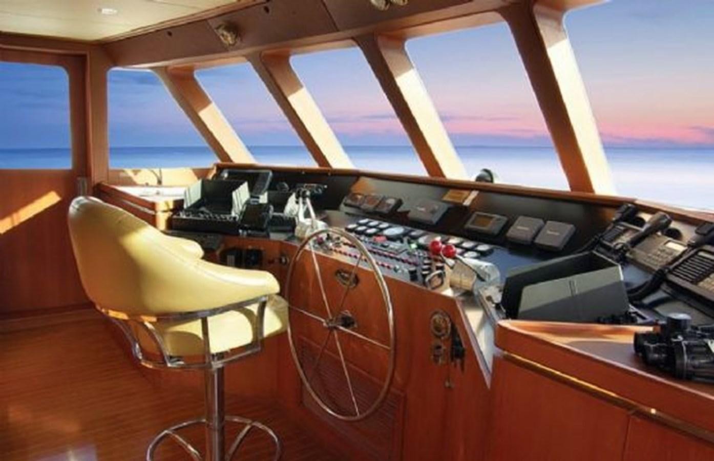 a room with a piano and a chair aboard HAPPY Yacht for Sale