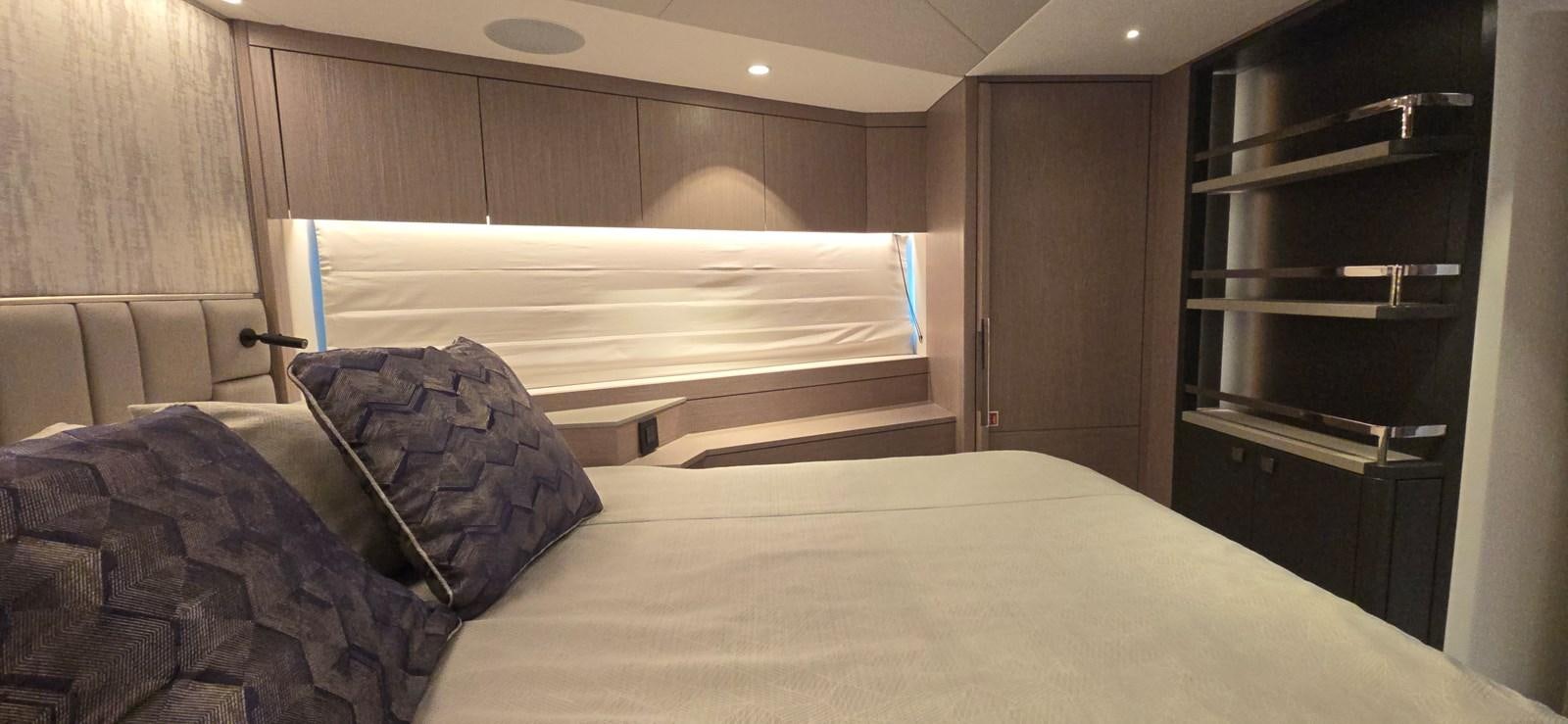a bed with a white sheet and a black cabinet aboard GABY Yacht for Sale