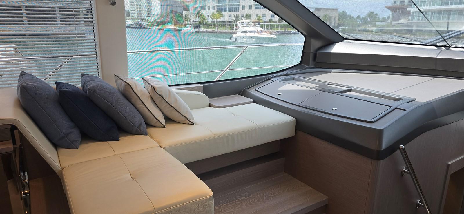 a room with a couch and a table with a laptop on it aboard GABY Yacht for Sale