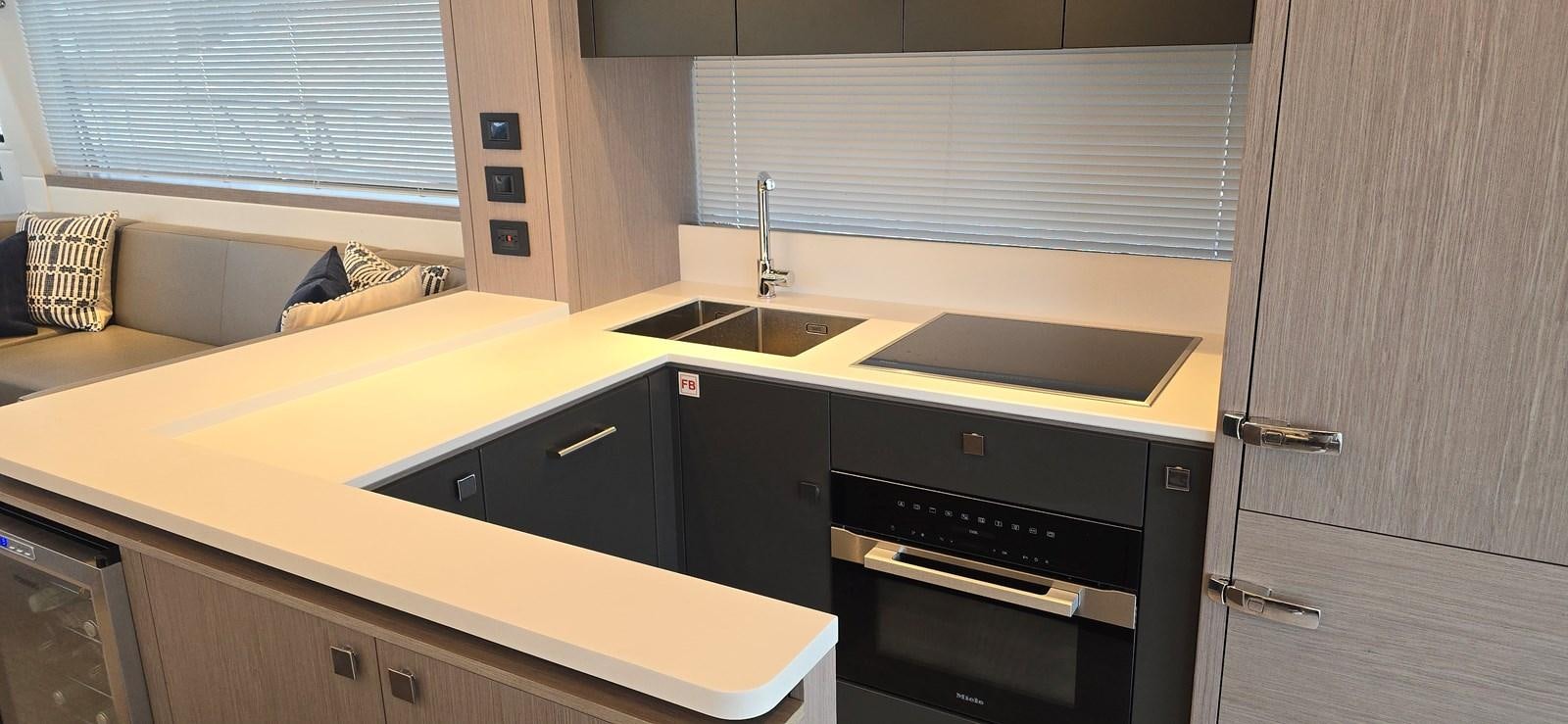 a kitchen with a sink and a couch aboard GABY Yacht for Sale