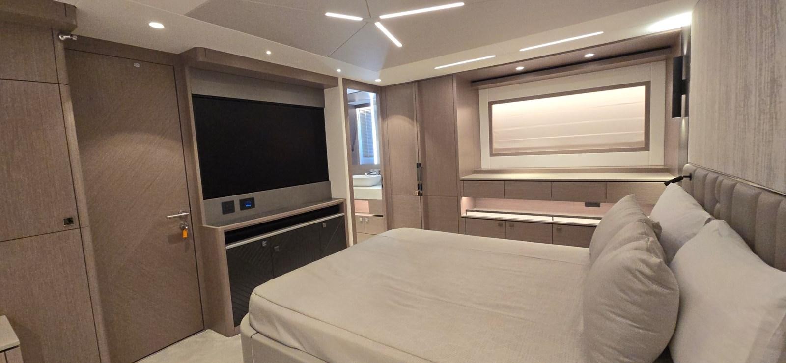 a room with a bed and a television aboard GABY Yacht for Sale