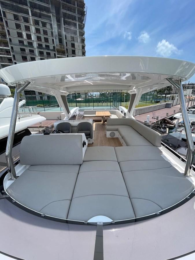a large white lounge chair in a room with a large white umbrella aboard GABY Yacht for Sale