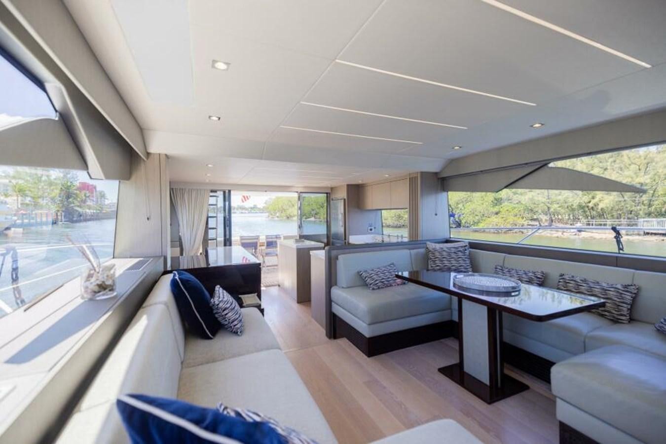a living room with a large table and couches aboard SEA ZAR Yacht for Sale