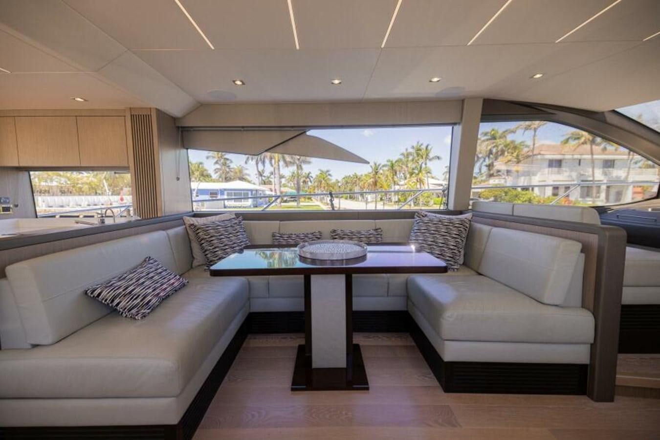 a living room with a table and couches aboard SEA ZAR Yacht for Sale