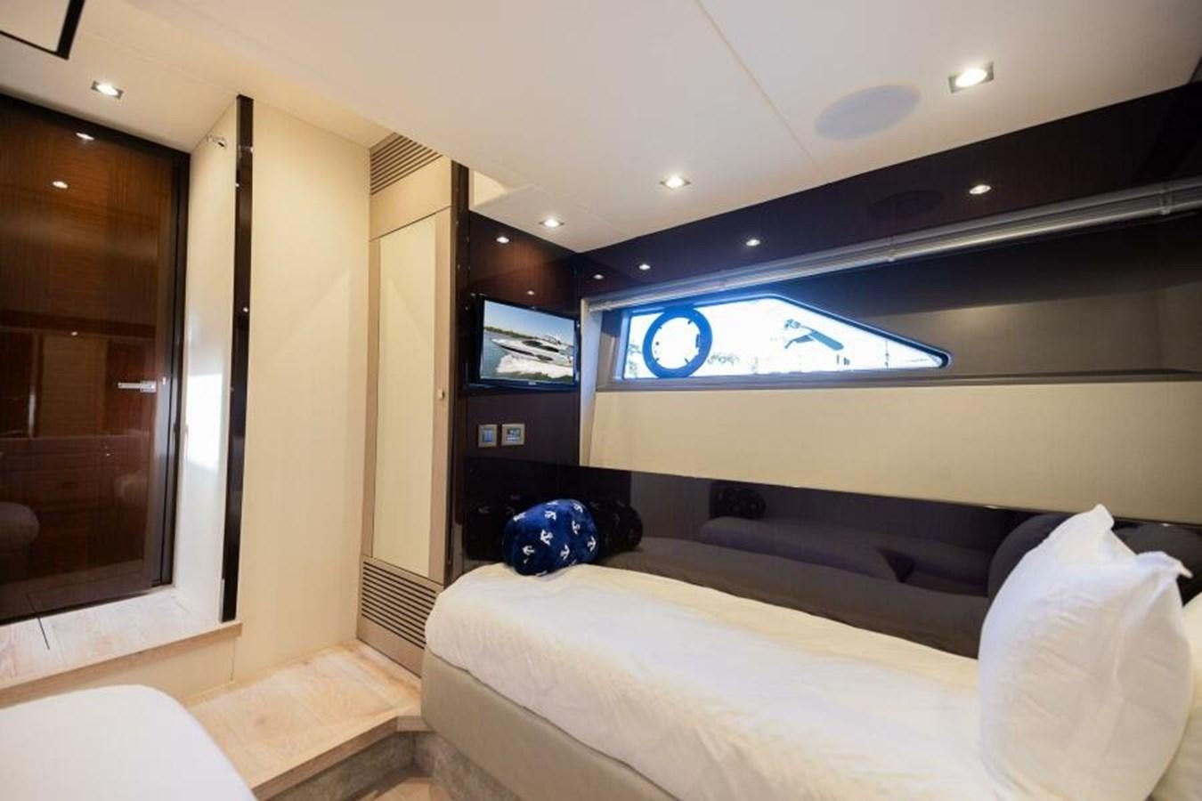 a bedroom with a bed and a tv on the wall aboard SEA ZAR Yacht for Sale
