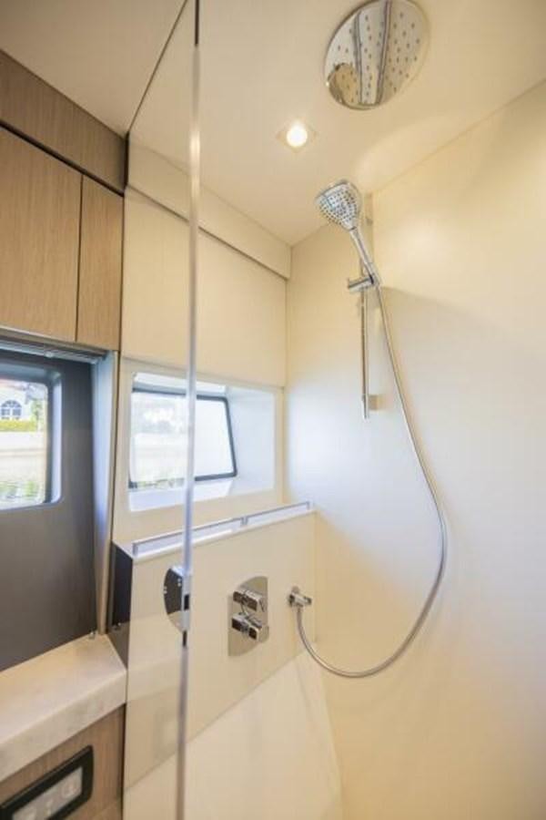 a shower with a sink and a mirror aboard SEA ZAR Yacht for Sale