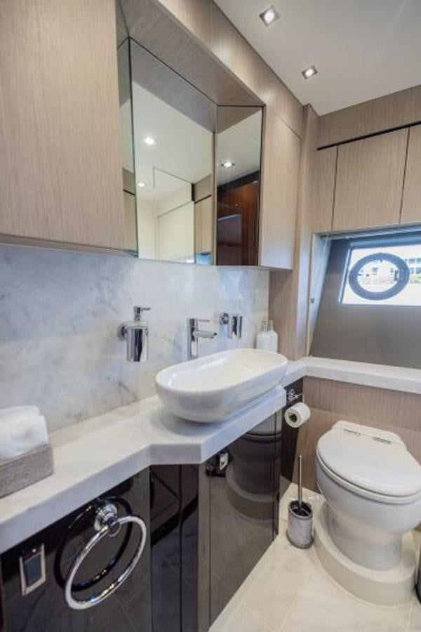 a bathroom with a sink toilet and a mirror aboard SEA ZAR Yacht for Sale