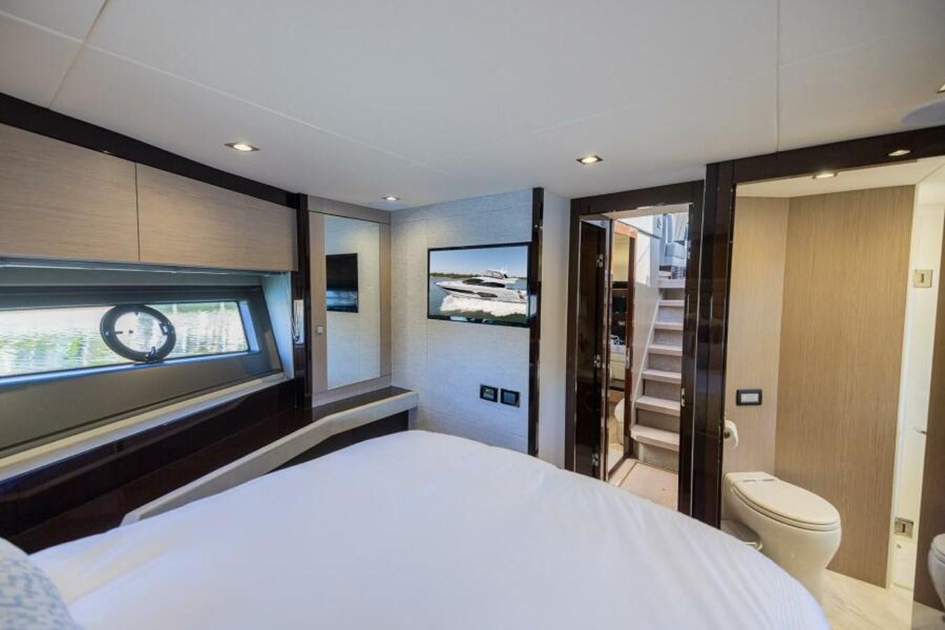 a bedroom with a large television aboard SEA ZAR Yacht for Sale