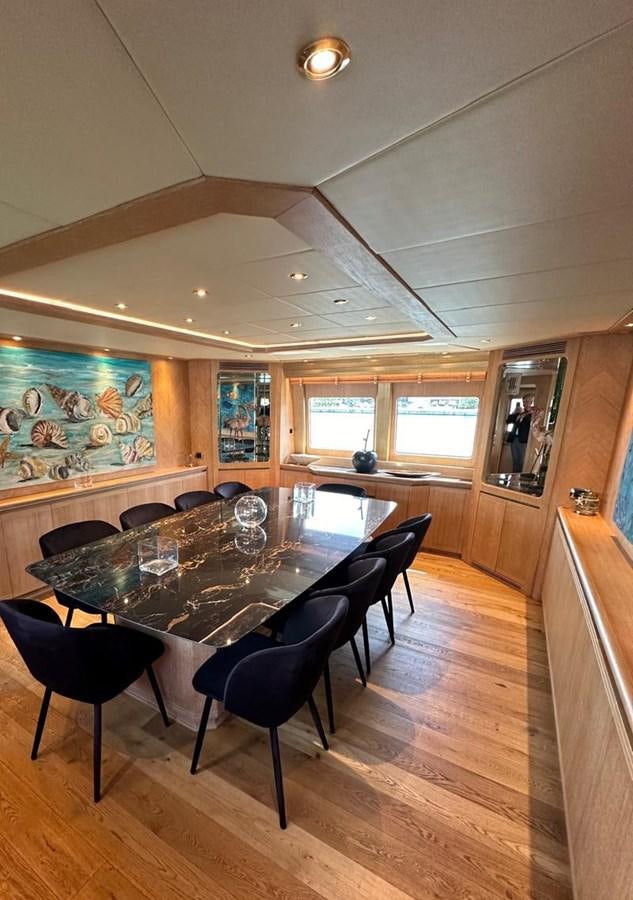 a dining room with a table aboard CHRISTINA V Yacht for Sale