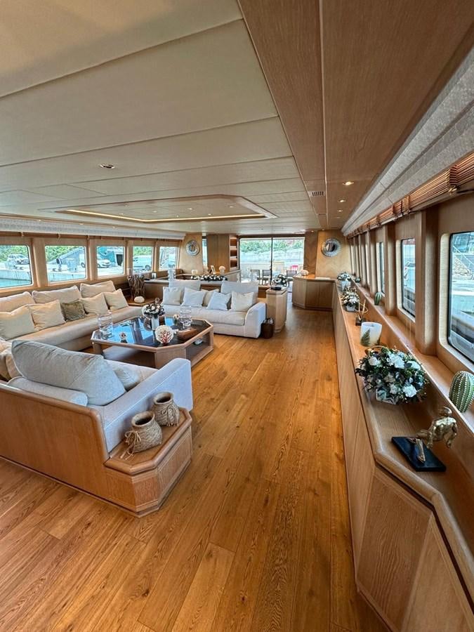 a living room with a large window aboard CHRISTINA V Yacht for Sale