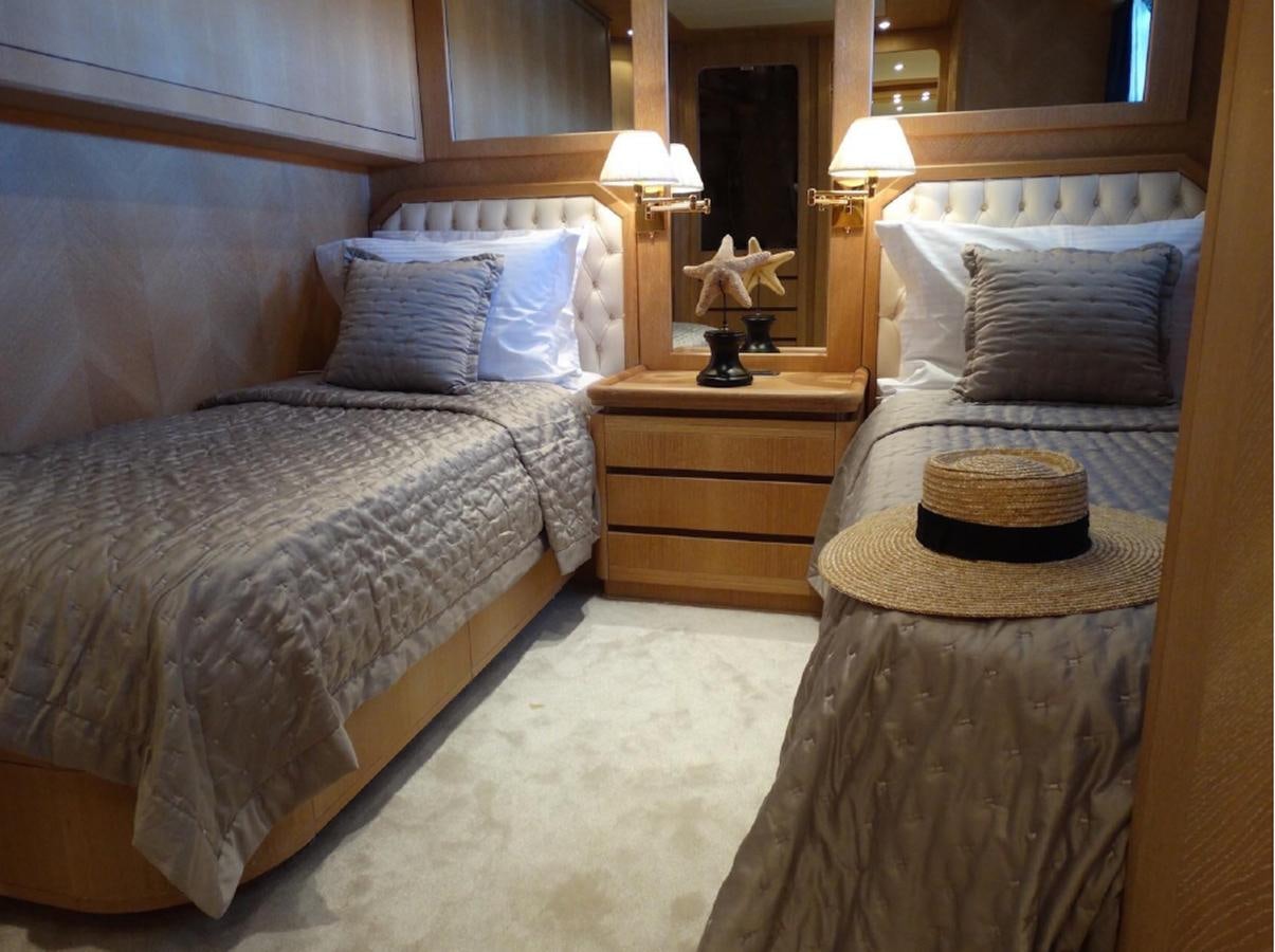 a bedroom with two beds aboard CHRISTINA V Yacht for Sale