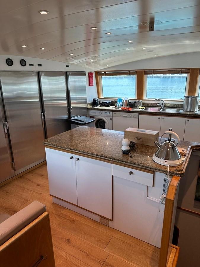 a kitchen with a large island aboard CHRISTINA V Yacht for Sale