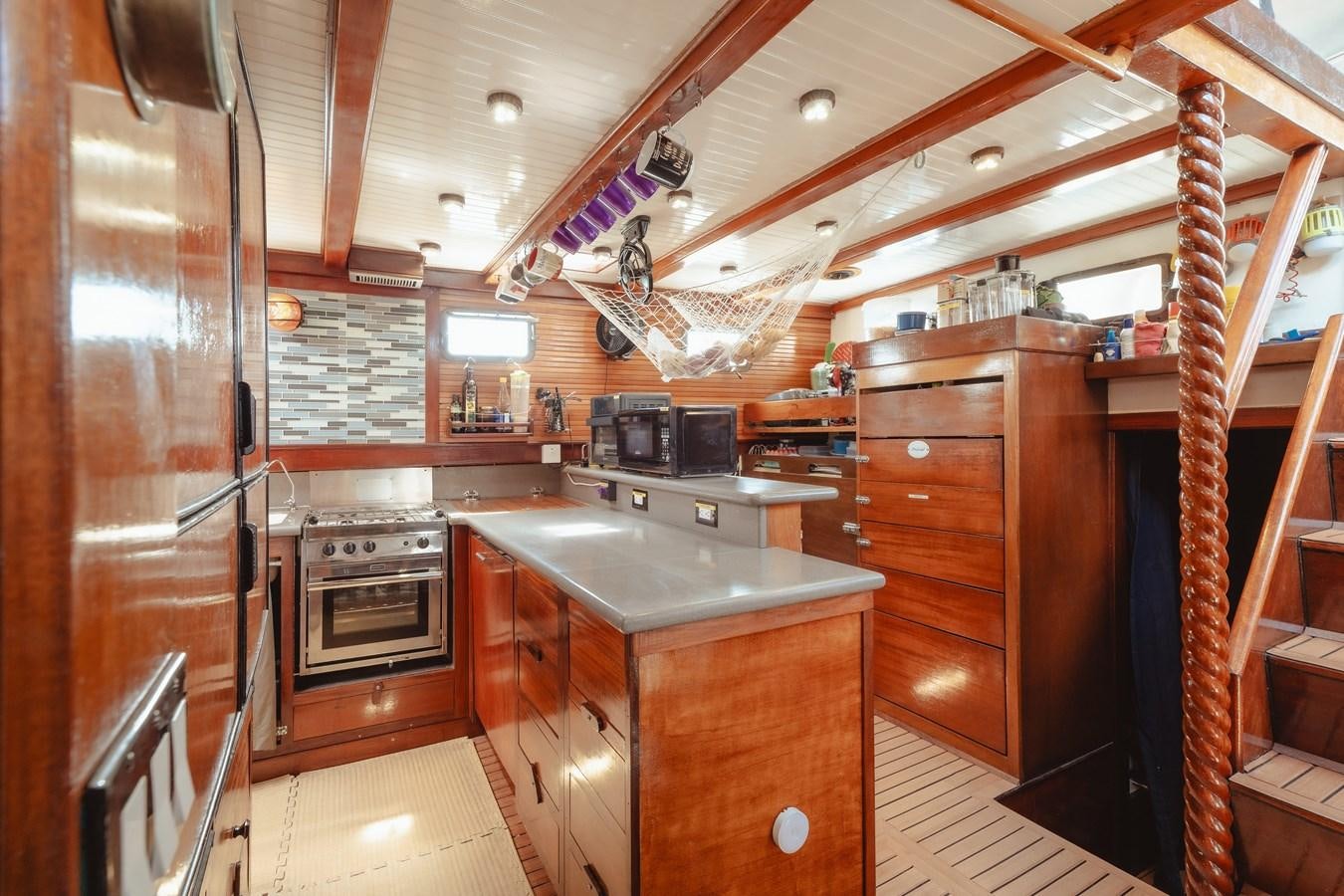 a kitchen with wooden cabinets aboard SJOSTROM Yacht for Sale