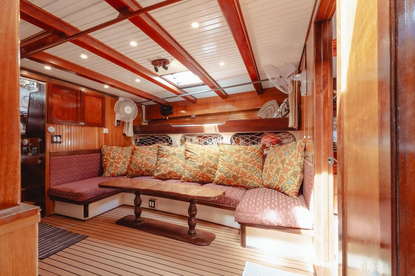 a living room with a wood wall aboard SJOSTROM Yacht for Sale