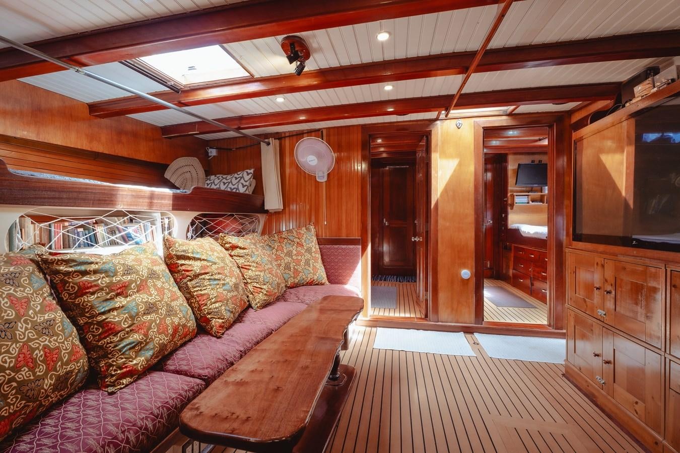 a living room with a wood floor aboard SJOSTROM Yacht for Sale