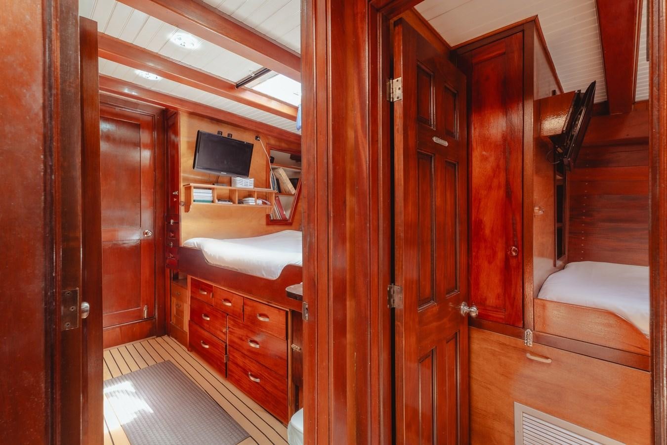 a room with a bed and a television aboard SJOSTROM Yacht for Sale