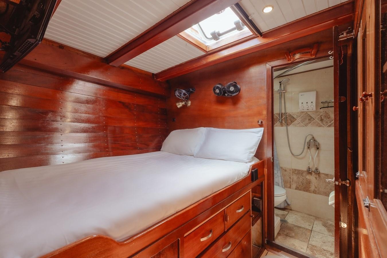 a bed with a white sheet aboard SJOSTROM Yacht for Sale