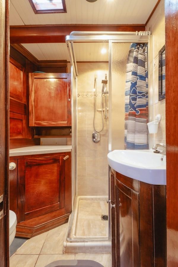 a bathroom with a shower and sink aboard SJOSTROM Yacht for Sale
