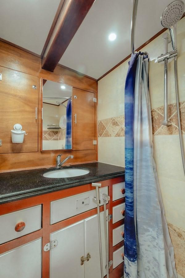 a bathroom with a sink and a mirror aboard SJOSTROM Yacht for Sale