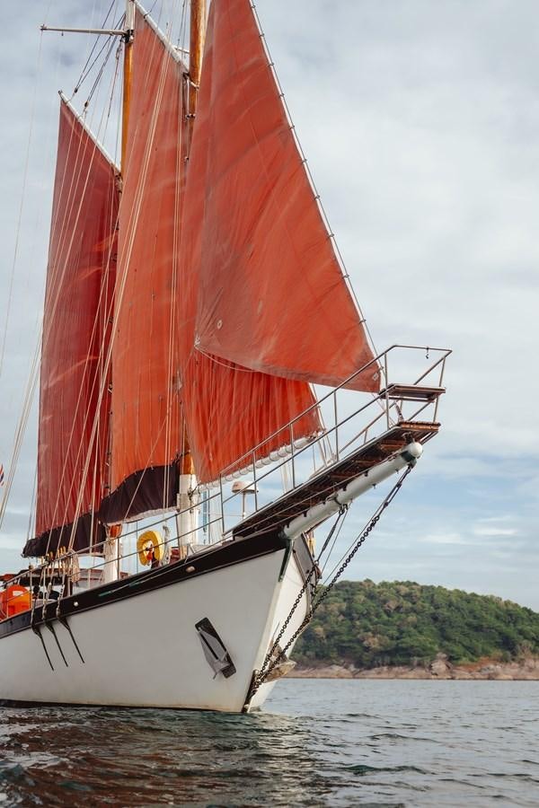 a red and white sailboat aboard SJOSTROM Yacht for Sale