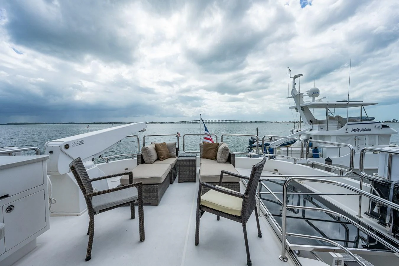 a deck with chairs and a table on it aboard MOIRA CINCO Yacht for Sale
