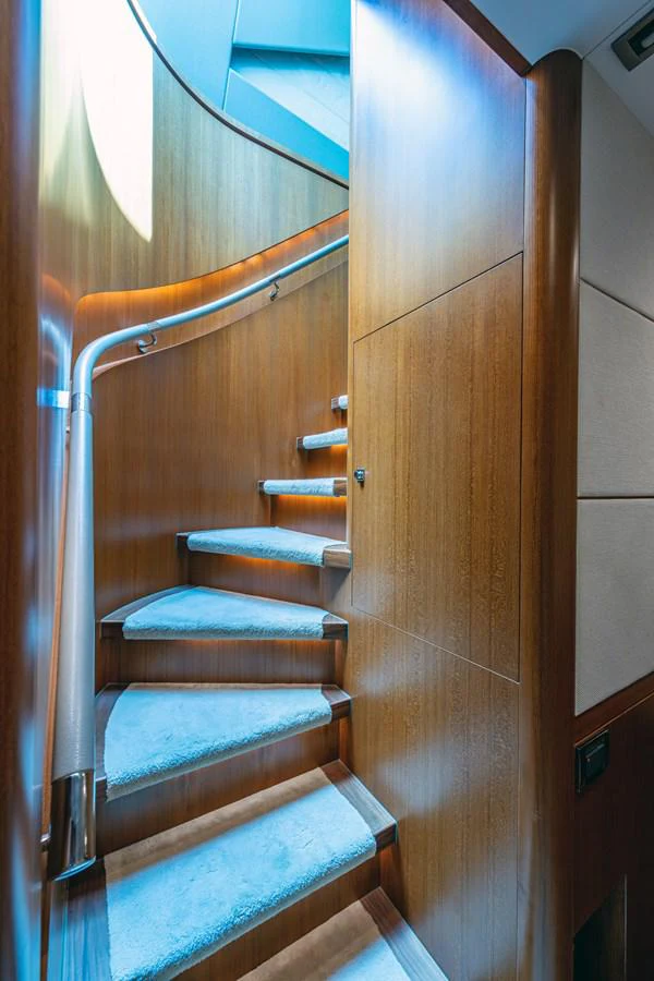 a staircase with a wood railing aboard MOIRA CINCO Yacht for Sale