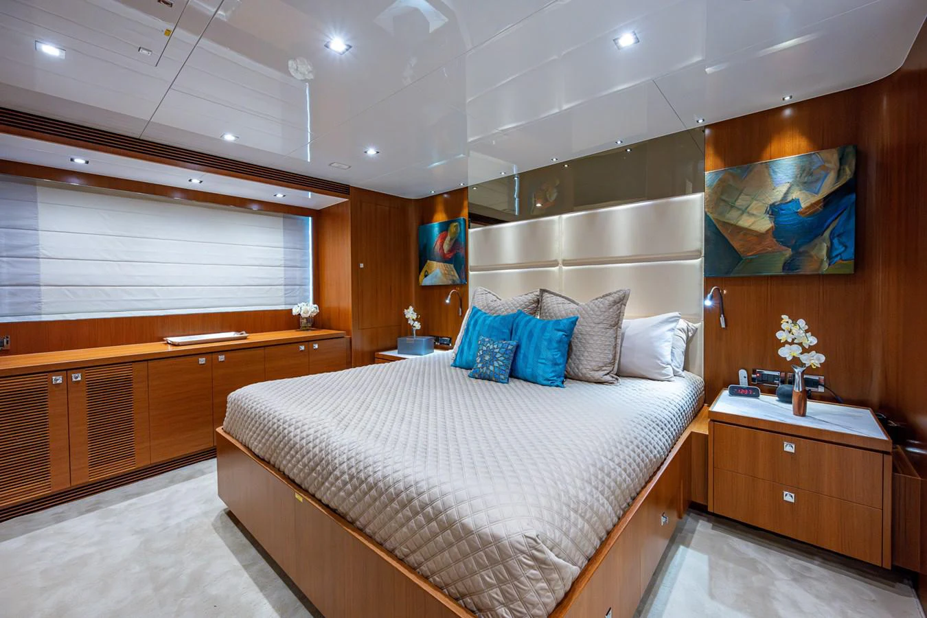 a bedroom with a bed and a window aboard MOIRA CINCO Yacht for Sale