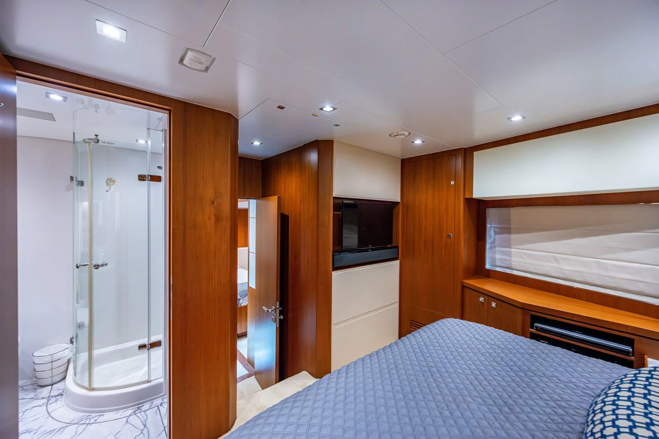 a bedroom with a bed and a closet aboard MOIRA CINCO Yacht for Sale