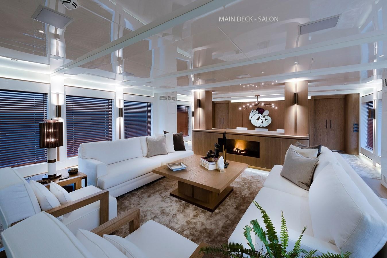 a living room with a fireplace aboard LIQUID SKY Yacht for Sale