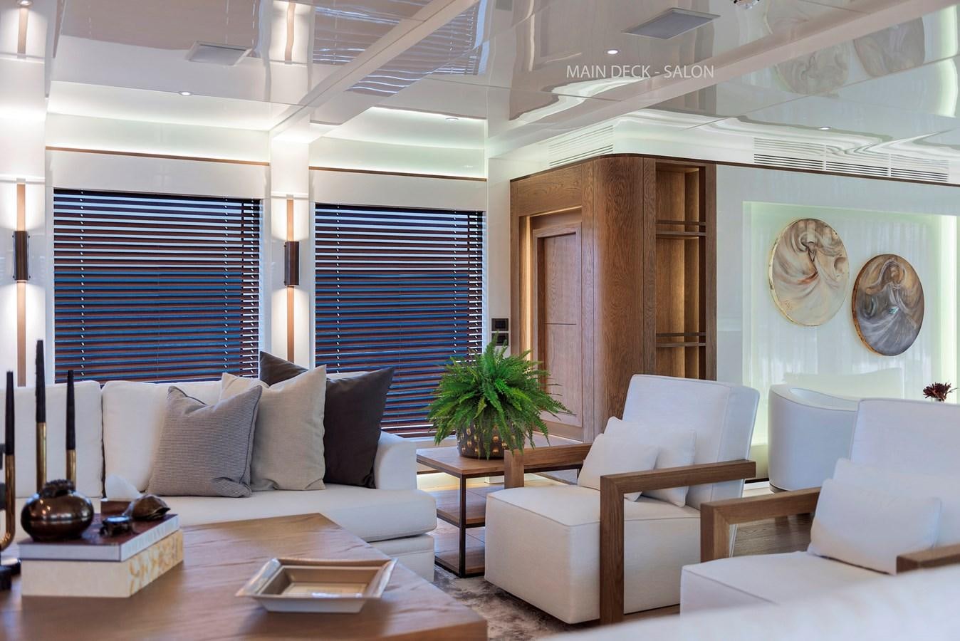 a living room with white couches aboard LIQUID SKY Yacht for Sale