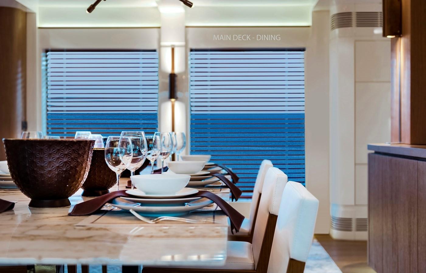 a table set with plates and glasses aboard LIQUID SKY Yacht for Sale