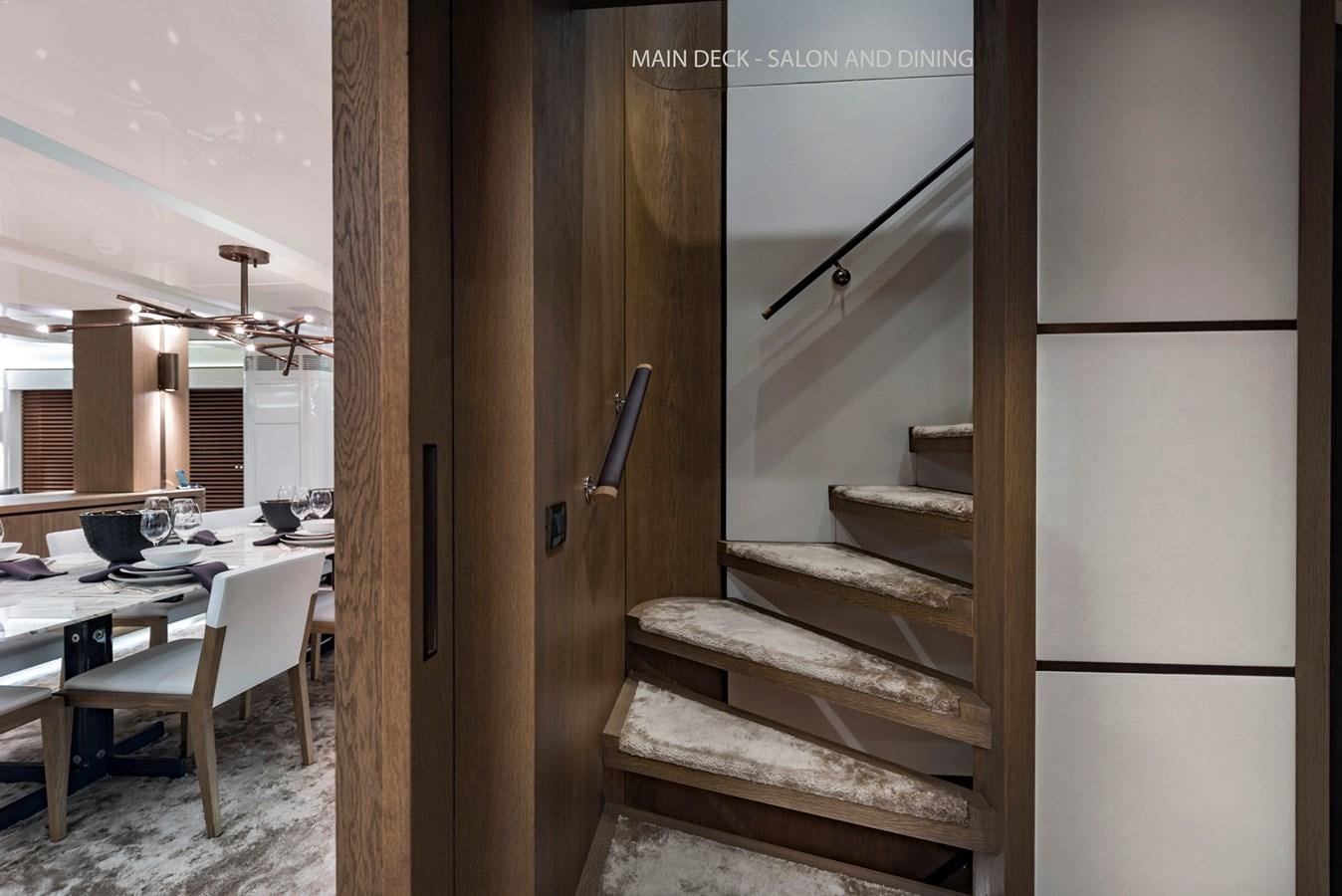 a wooden staircase in a house aboard LIQUID SKY Yacht for Sale