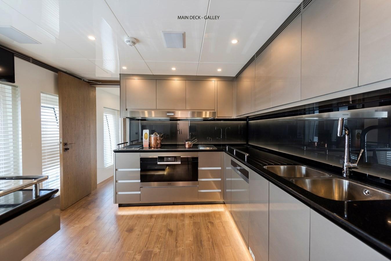 a kitchen with a large island aboard LIQUID SKY Yacht for Sale