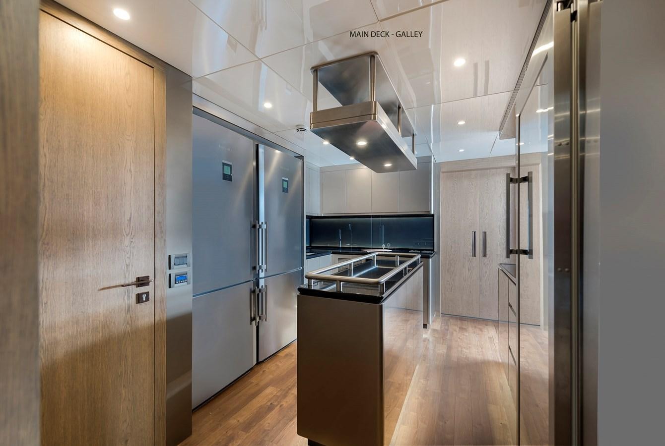 a kitchen with a large refrigerator aboard LIQUID SKY Yacht for Sale