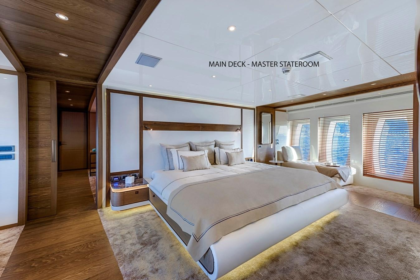 a room with a bed and a mirror aboard LIQUID SKY Yacht for Sale