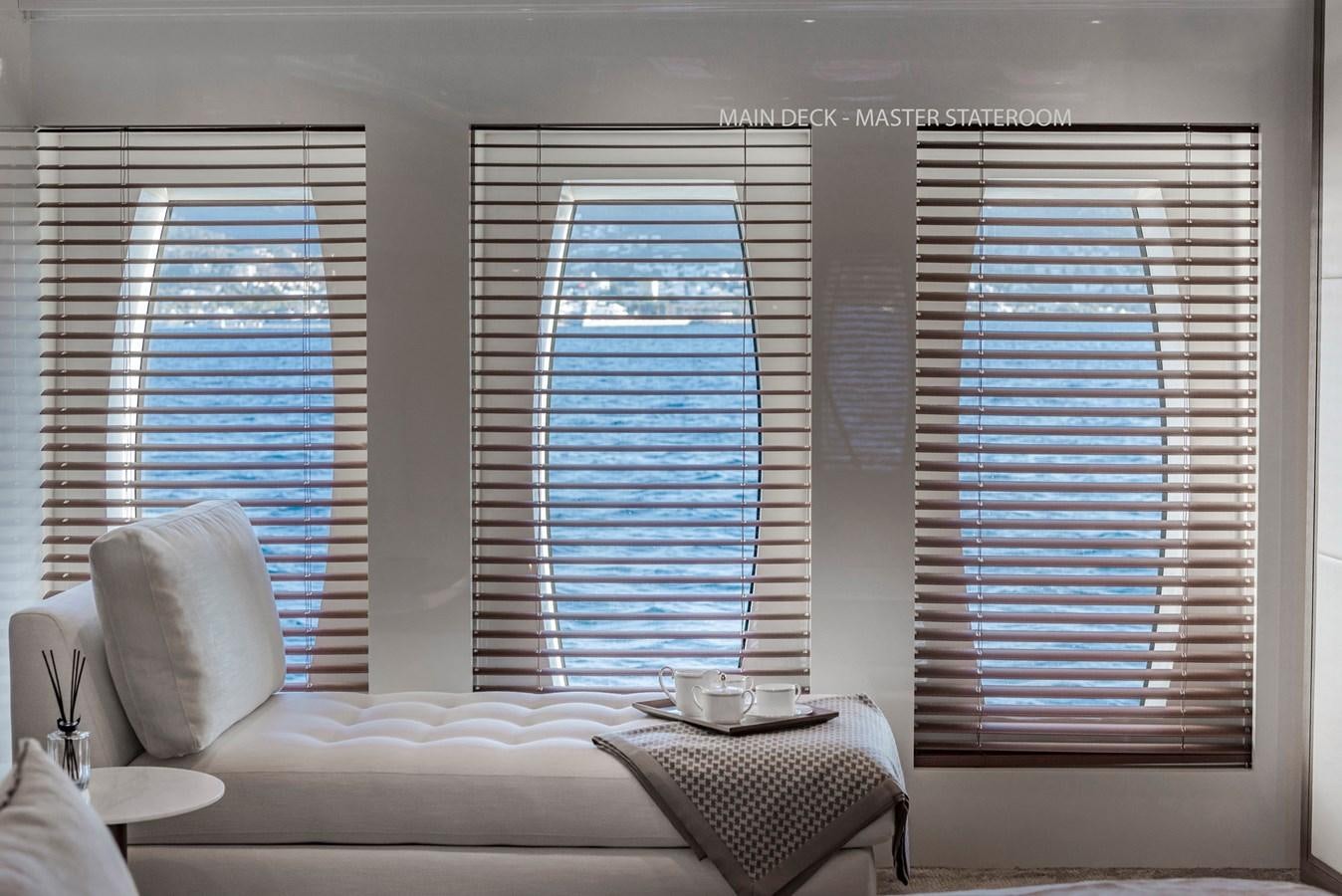 a room with a couch and a window aboard LIQUID SKY Yacht for Sale