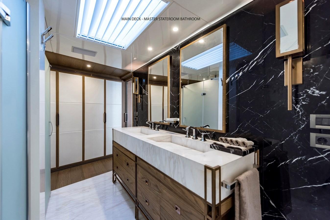 a bathroom with a large mirror aboard LIQUID SKY Yacht for Sale