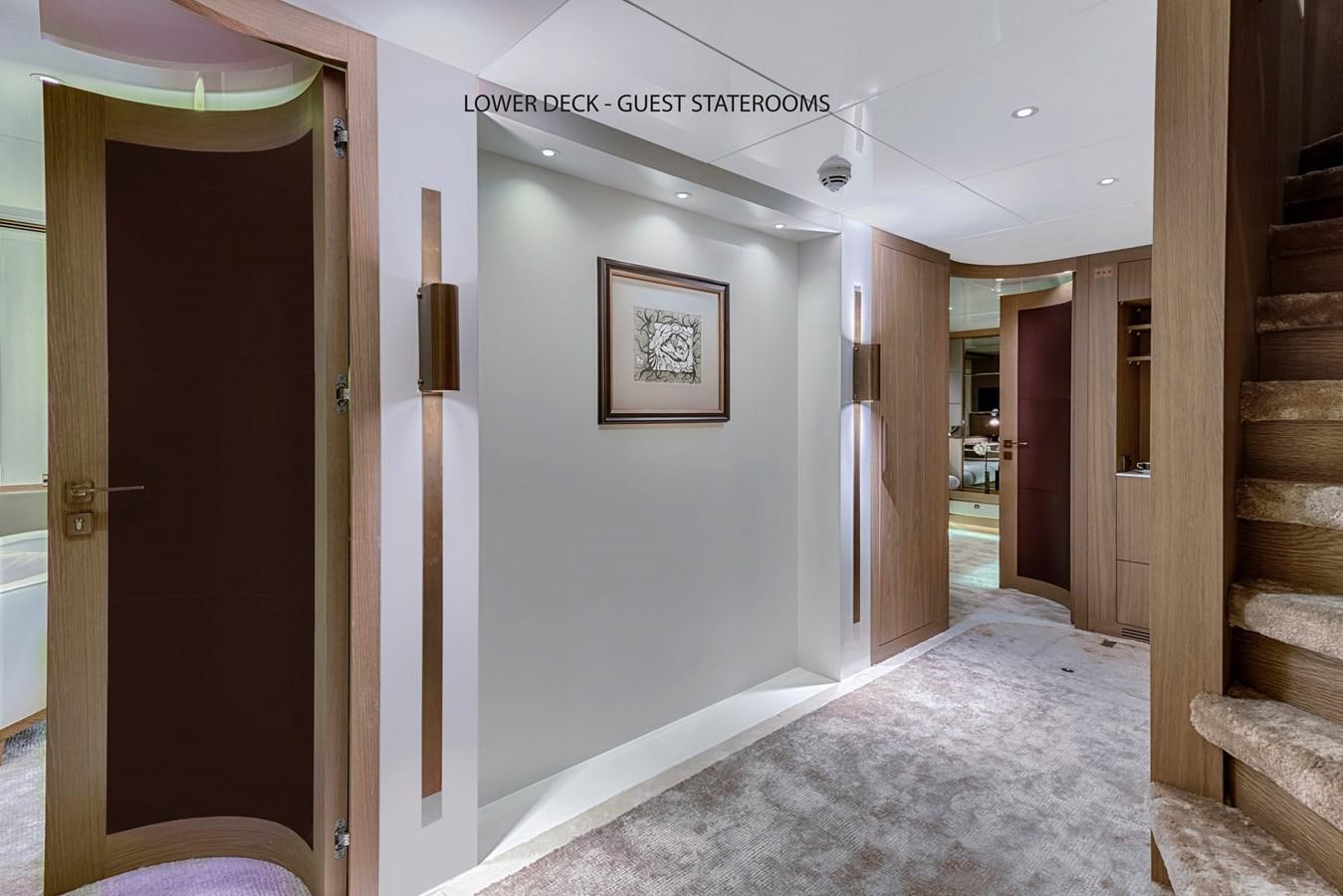 a hallway with a carpet and wood doors aboard LIQUID SKY Yacht for Sale