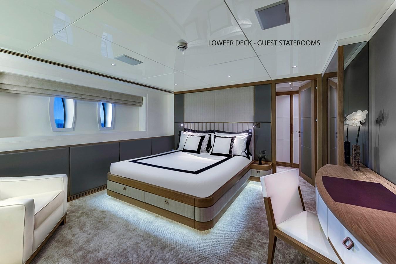 a room with a bed and a couch aboard LIQUID SKY Yacht for Sale