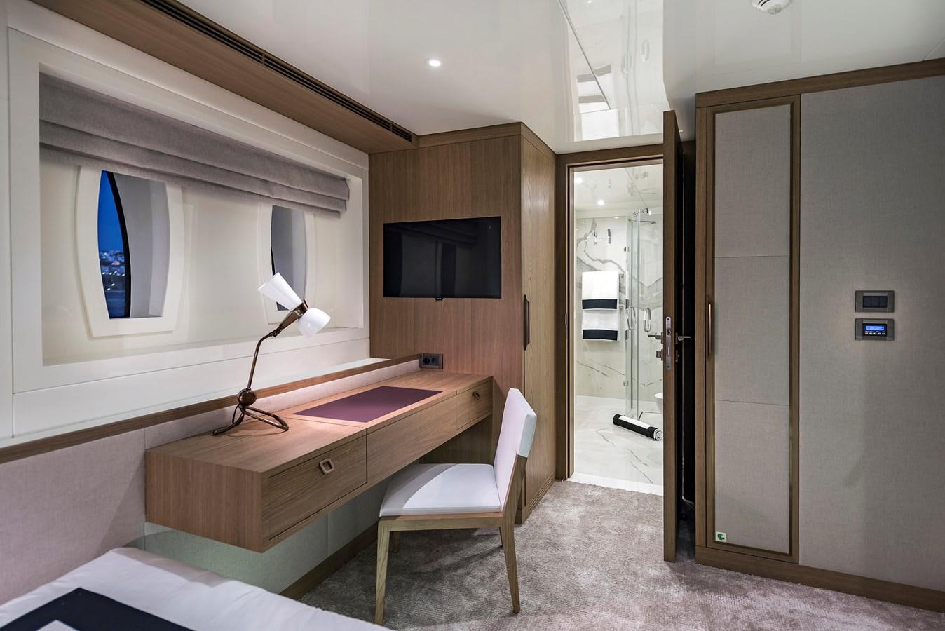 a room with a desk and a tv aboard LIQUID SKY Yacht for Sale