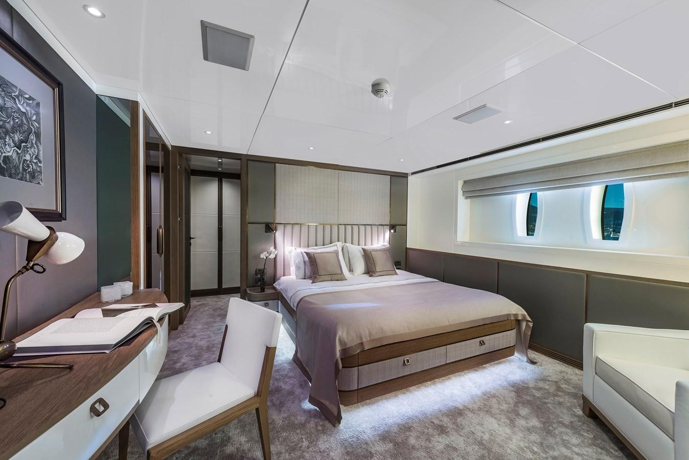 a room with a bed and a chair aboard LIQUID SKY Yacht for Sale