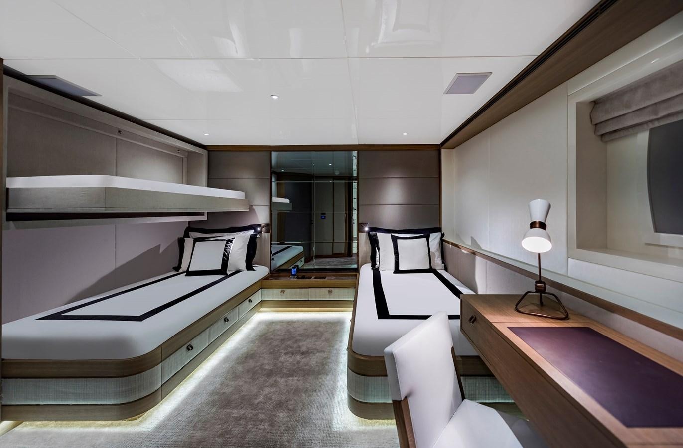 a room with a bed and a desk aboard LIQUID SKY Yacht for Sale