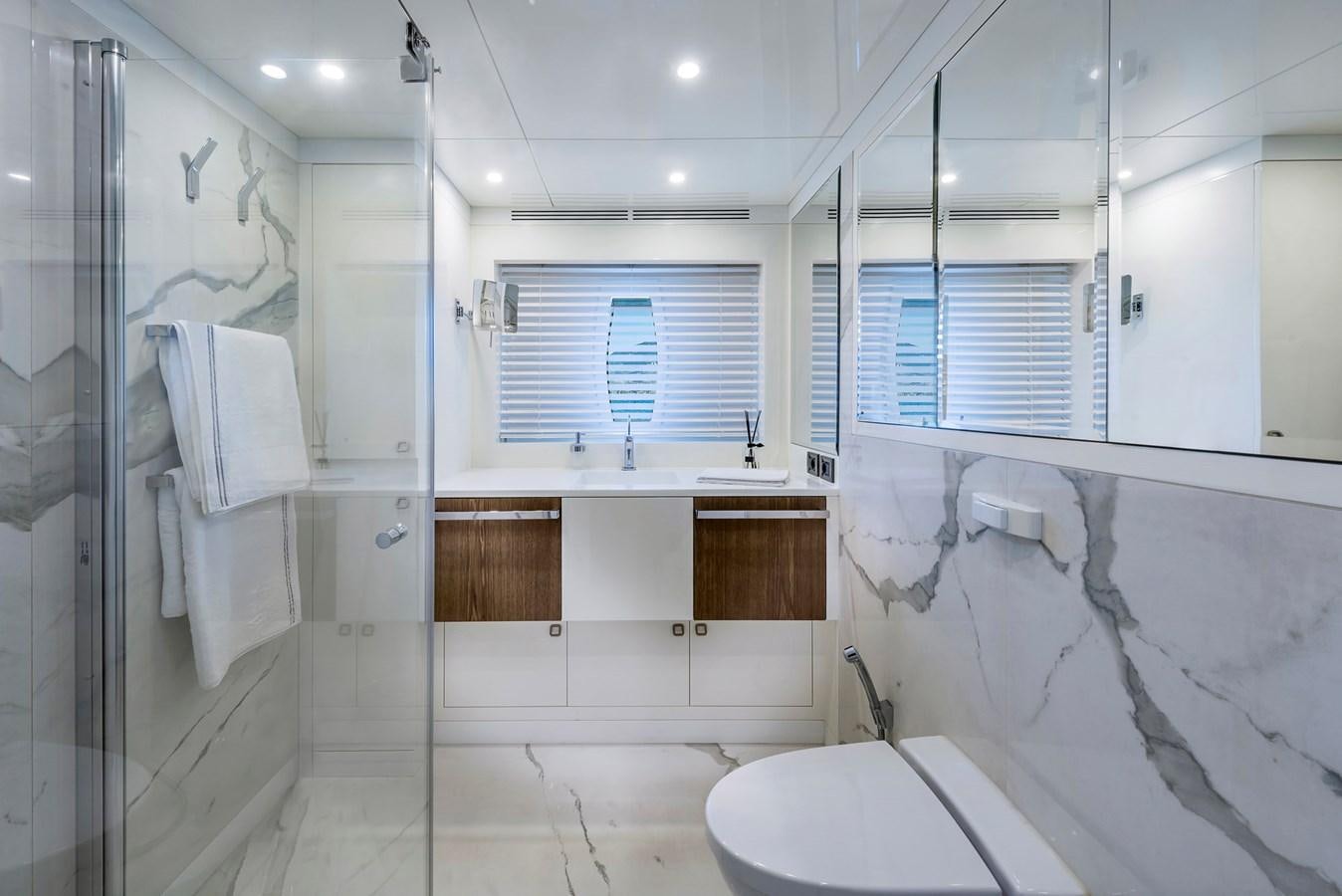 a bathroom with a shower and toilet aboard LIQUID SKY Yacht for Sale
