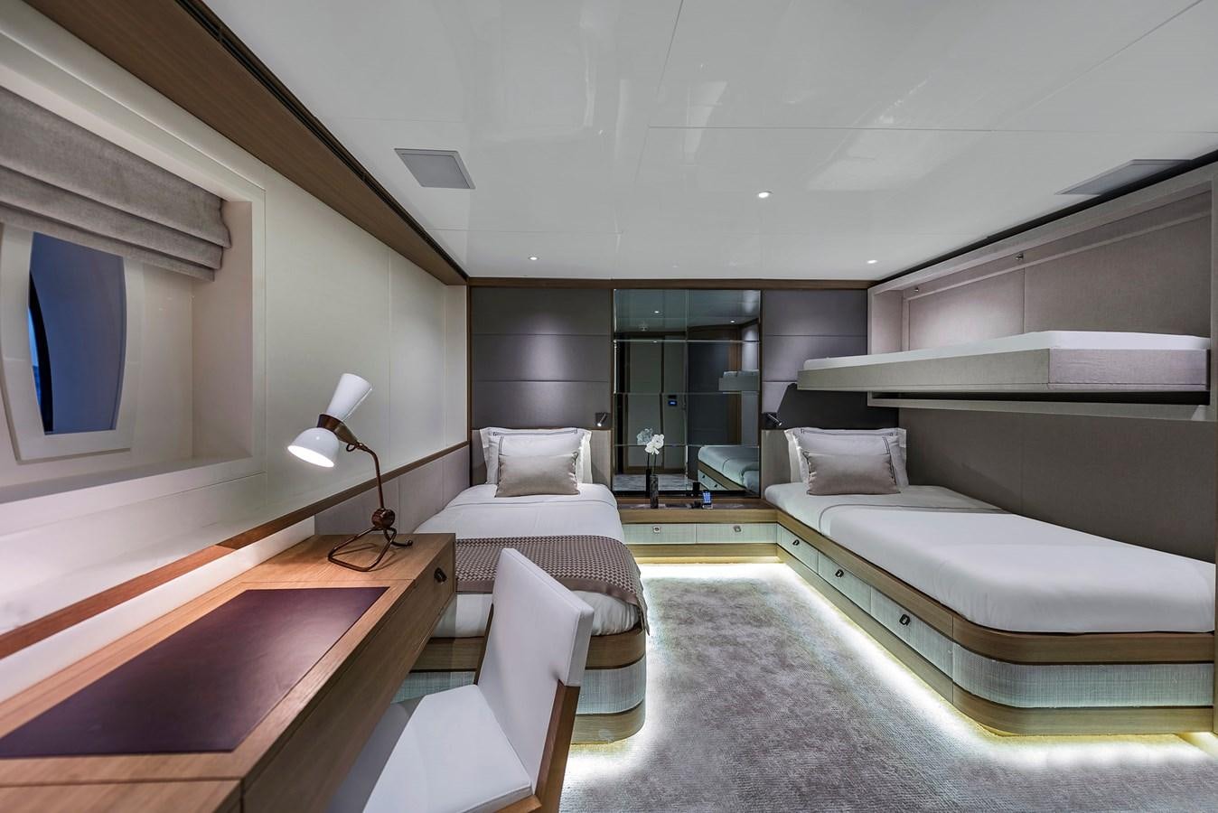 a room with a bed and a couch aboard LIQUID SKY Yacht for Sale