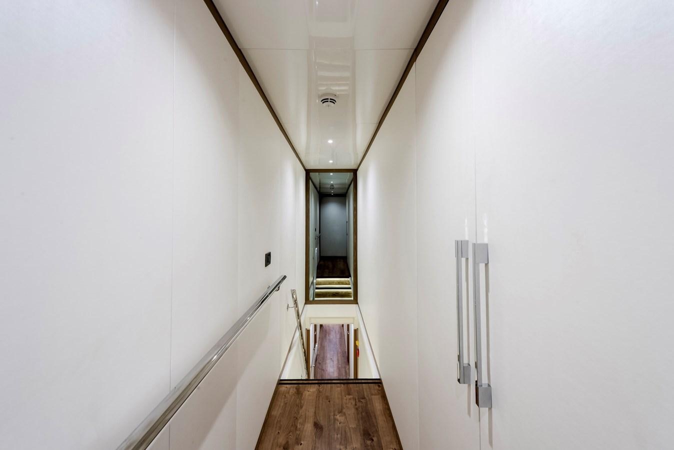 a hallway with a door and a light on the ceiling aboard LIQUID SKY Yacht for Sale