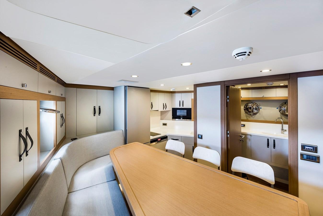 a large kitchen and dining room aboard LIQUID SKY Yacht for Sale