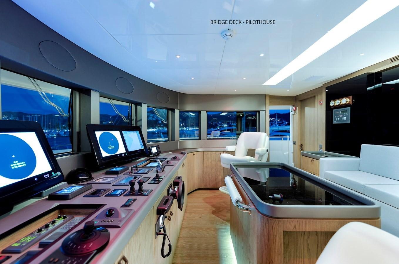 a room with a desk and several screens aboard LIQUID SKY Yacht for Sale