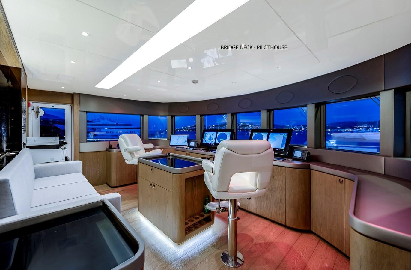 a room with a desk and chairs aboard LIQUID SKY Yacht for Sale
