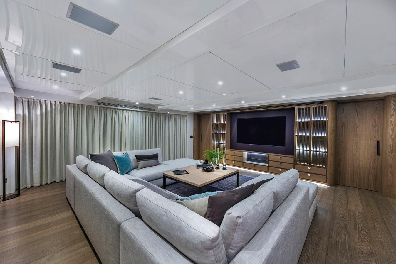 a living room with a couch and a tv aboard LIQUID SKY Yacht for Sale