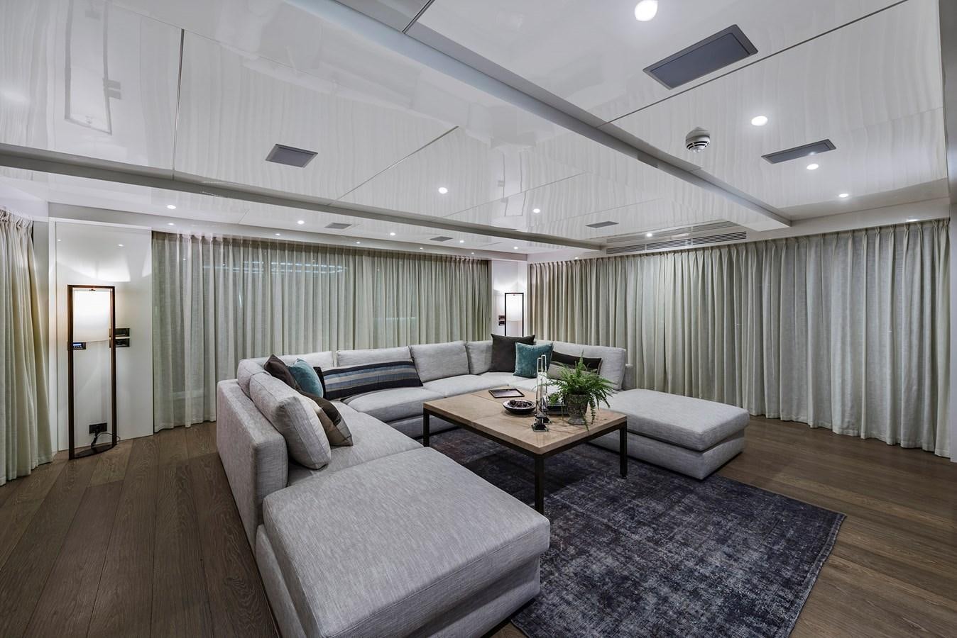 a living room with a couch and a coffee table aboard LIQUID SKY Yacht for Sale